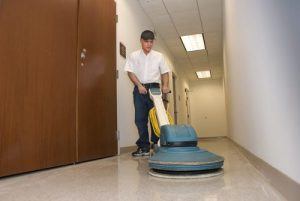 24/7 commercial cleaning services in NYC being provided. Cleaning service expert is maintaining commercial building floors.