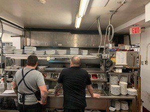 Staff looking at kitchen. Restaurant cleaning services NYC are provided by professional kitchen cleaning companies in New York City to keep kitchens like this clean.