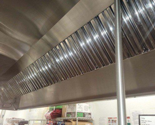 Image of a clean kitchen hood. Exhaust hood cleaning services are a crucial part of fire prevention for restaurants in NYC.
