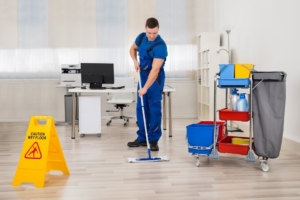Professional cleaner mopping the floor in a New York City office.