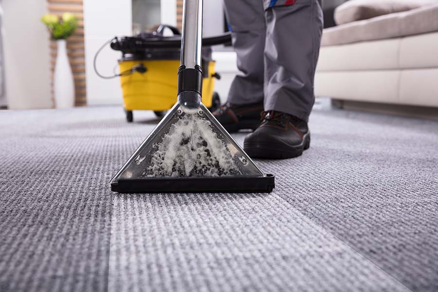 NYC commercial carpet cleaning for offices being performed by a SanMar cleaning technician.