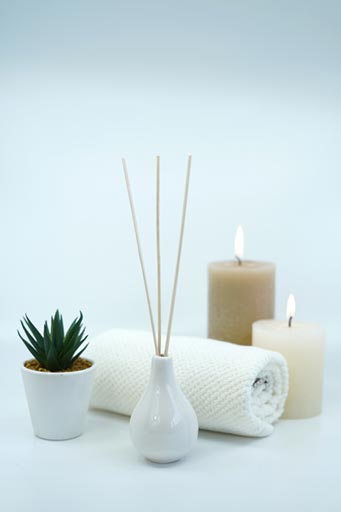 Candles and rolled up towel with aromatherapy in an NYC spa. Cleaning with eco-friendly products are used by SanMar Building Services to ensure your Manhattan spa is professional cleaned.