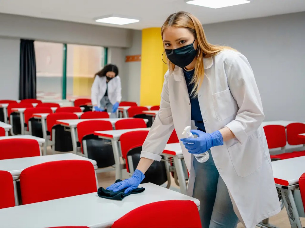 New York City school cleaning services include wiping down and disinfecting surfaces like desks and tables.